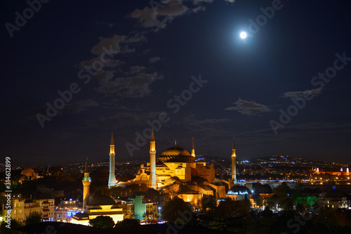 Night lights on Hagia Sophia under a clear full moon at night in Istanbul Turkey