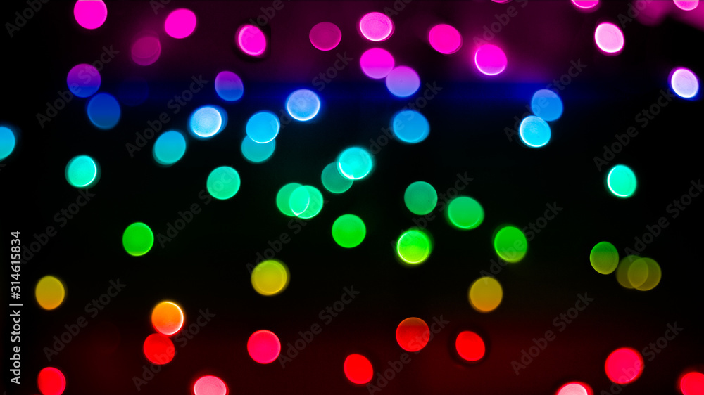 rainbow colored bokeh lights on dark background rainbow colored bokeh lights on dark background