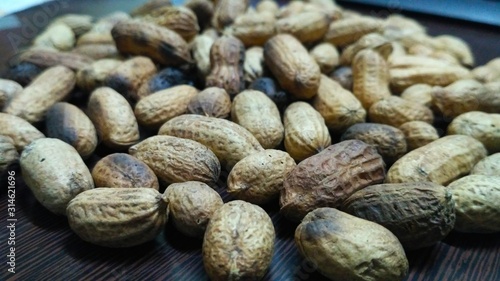 Peanuts in shell scattered in table