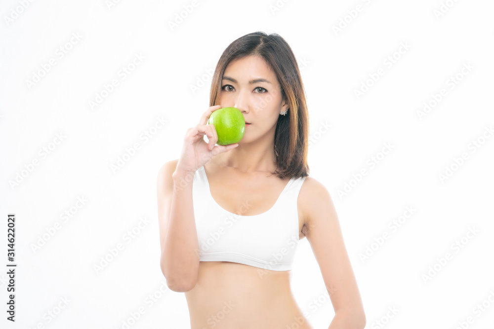 Beautiful asian young woman healthy food wearing white underwear eating green apple with healthy food isolated on a white background. Beautiful asian young woman healthy food wearing white underwear eating green apple with healthy food isolated on a white background.