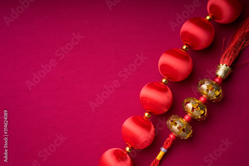 Chinese New Year decorations with red background with assorted festival decorations. Chinese characters means abundant of wealth, prosperity and luck. Flat lay.