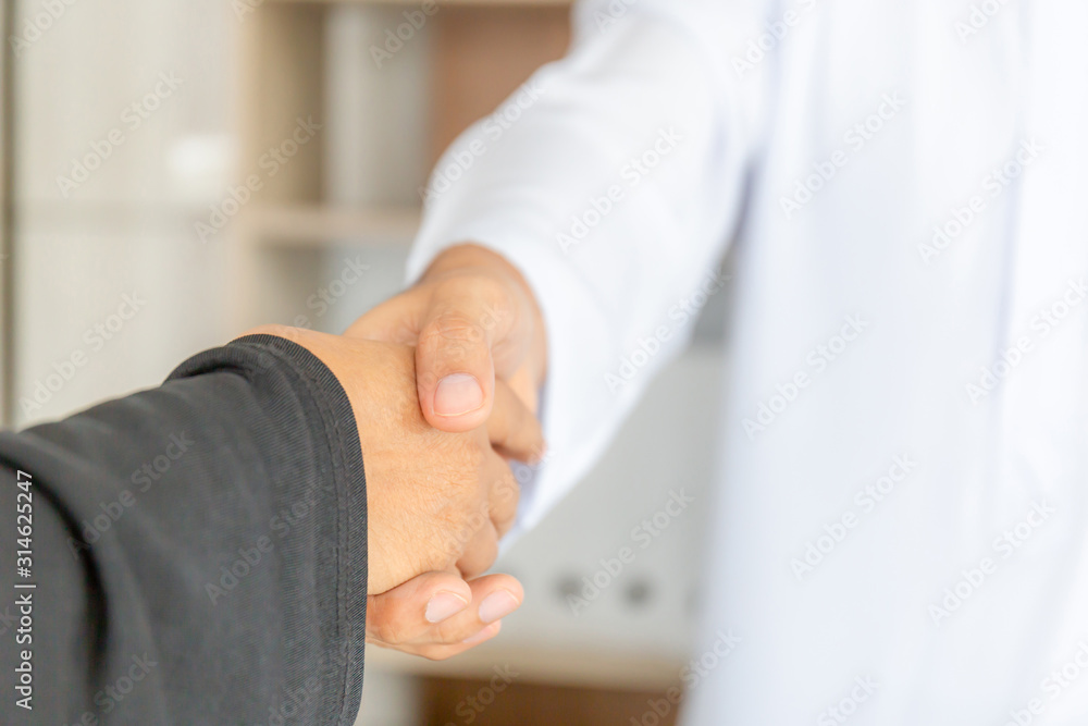 Arab middle eastern businessman and business woman make handshakes, finishing up meeting