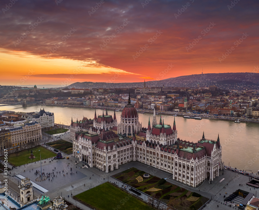 Budapest, Hungary - Aerial view of the Hungarian Parliament building on a winter afternoon with a spectacular colorful sunset. Fisherman's Bastion, Buda Castle and Szechenyi Chain bridge at background