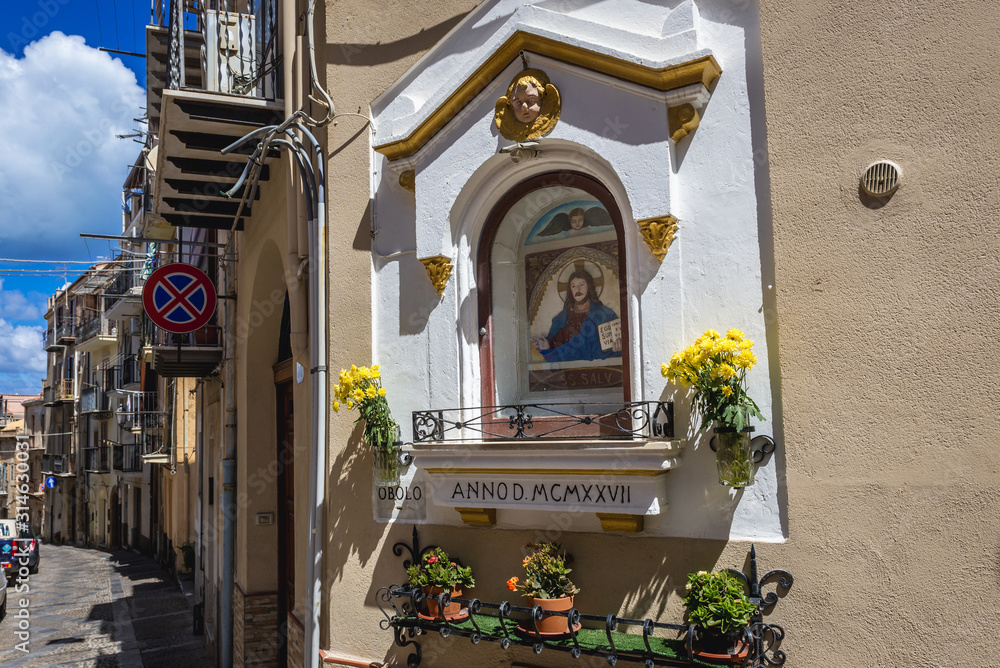 Roman Catholic shrine on a street in the Old Town of Cefalu city on Sicily Island in Italy