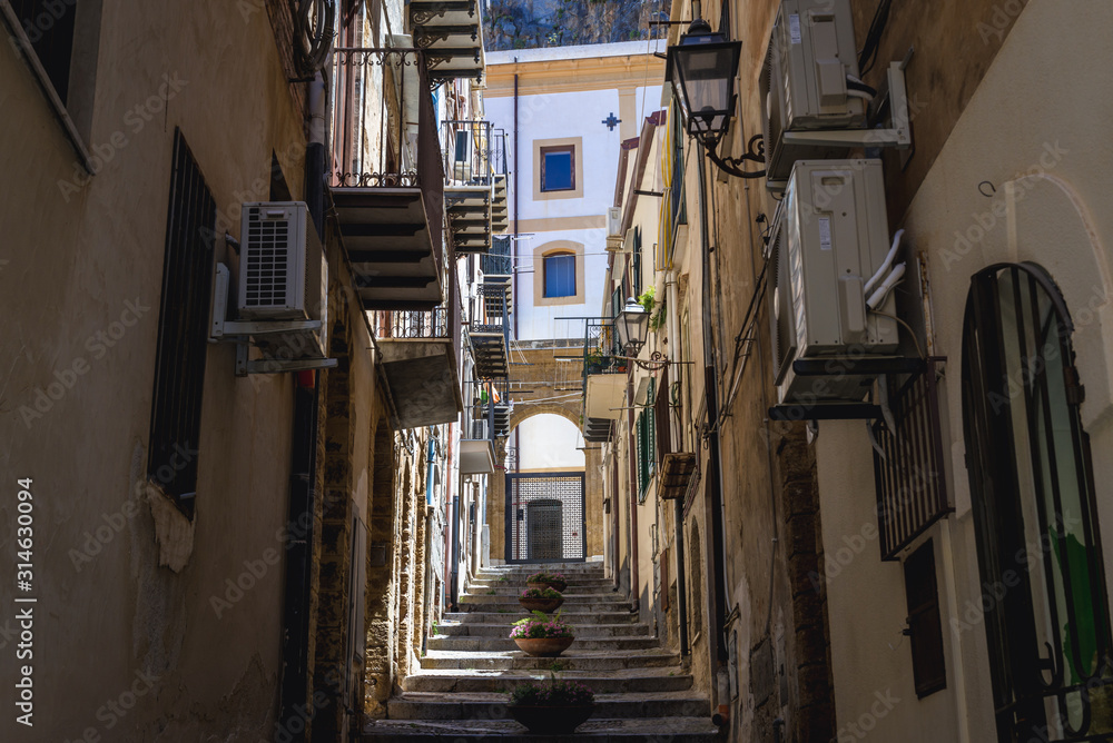 Fototapeta premium Stairs between townhouses on the Old Town of Cefalu city on Sicily Island in Italy