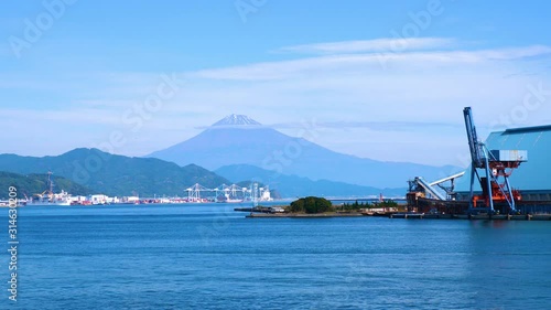 4K VDO of Fuji mountain landscape view over blue sky and white cloud from the ferry boat in the ocean at Suruga Bay, Shizuoka, Japan