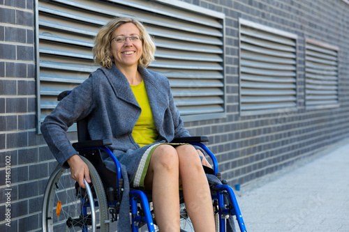 young adult woman on wheelchair on the street