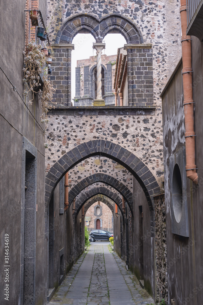 Arch Street - Via Degli Archi in historic part of Randazzo city on Sicily Island in Italy, view with tower of Saint Nicholas Church