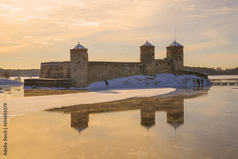 View of the old Olavilinna fortress at sunrise on a March morning. Savonlinna, Finland