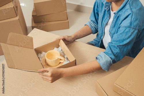 Young Asian small business owner, online marketing packaging box and delivery