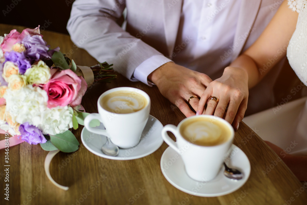 Wedding couple drink coffee and holding hands. Wedding card Wedding couple drink coffee and holding hands. Wedding card