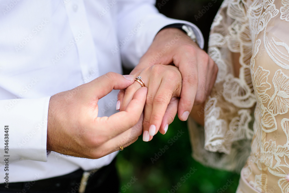 Wedding engagement rings. Newlywed couple's hands with engagement rings.