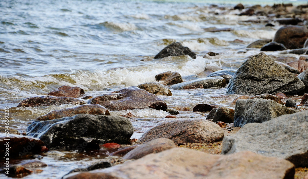 Fototapeta premium sea shore, stones on the shore, close-up, blurred background