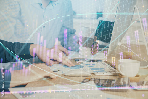 Multi exposure of chart with man typing on computer in office on background. Concept of hard work.