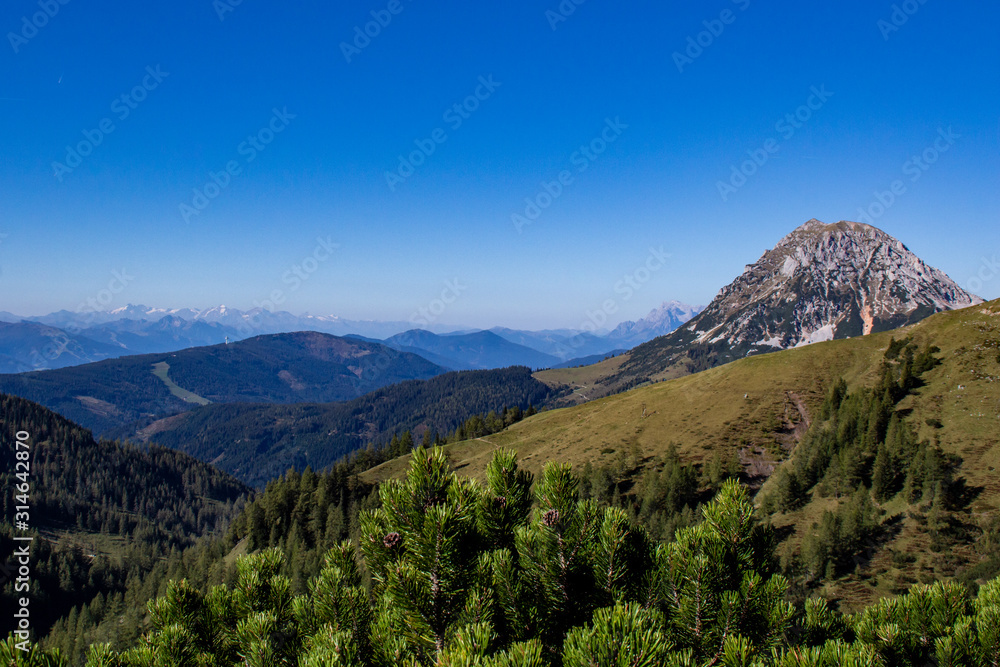 bright blue sky near a glacier in the alps at the dachstein glacier look into a valley of hiking trails