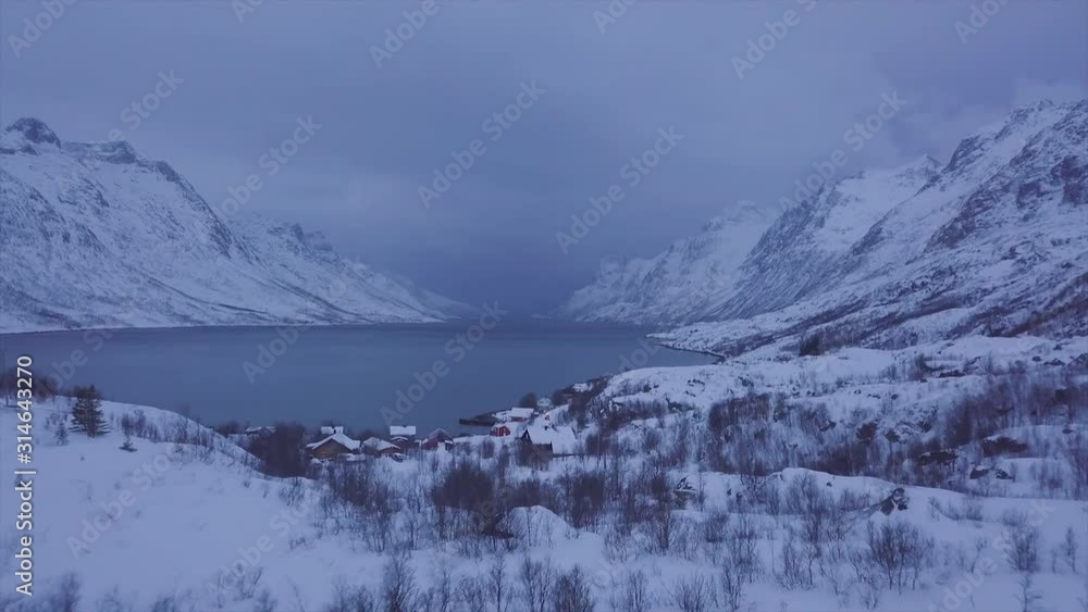 custom made wallpaper toronto digitalReverse drone flying with fjord and small town in background, northern Norway.