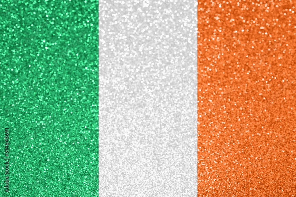 Fototapeta premium Ireland national flag. St Patrick's day, festive holiday background. Defocused glitter texture