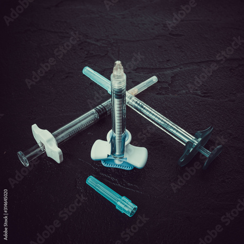 Medical injection syringes with solution on black background