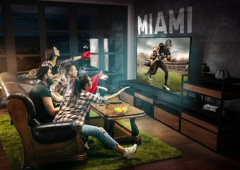 Group of friends watching TV, american football match, championship. Emotional men and women cheering for favourite team, look on fighting for ball. Concept of friendship, sport, competition, emotions