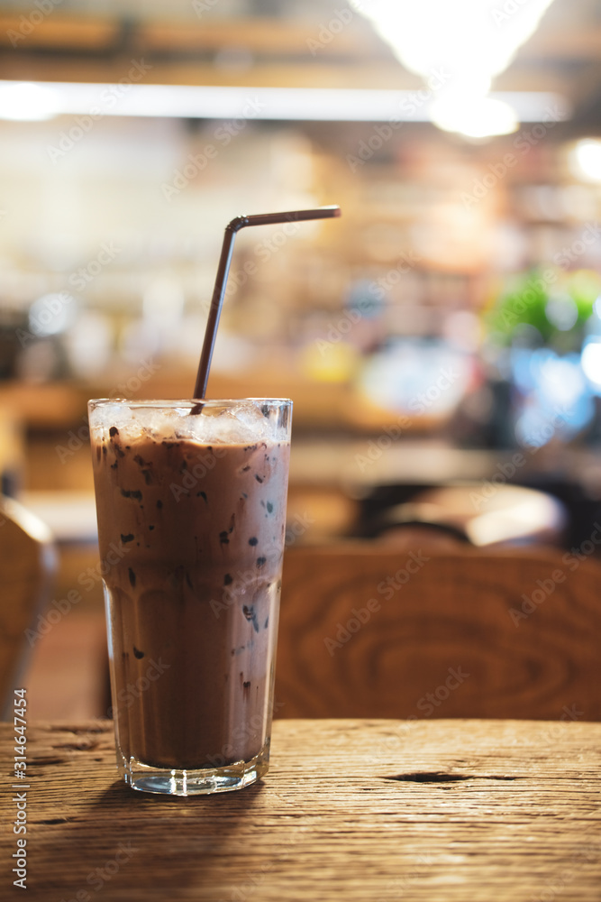 Iced Mocha coffee in glass on the wooden table Iced Mocha coffee in glass on the wooden table