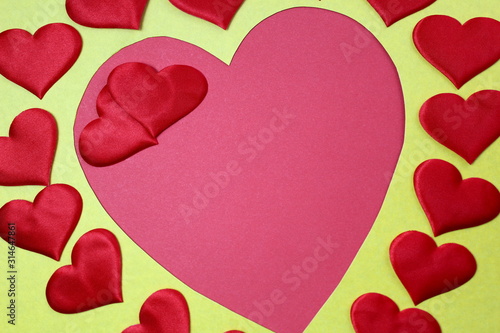 Abstract background in the form of many hearts of red color and one big