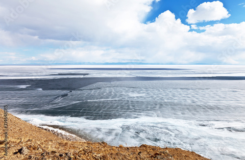 Lake Baikal on a spring sunny day. View of the ice drift and the destruction of the ice cover from Olkhon Island. Beautiful spring landscape. Natural background