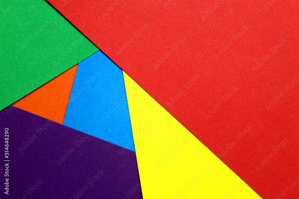 colored cardboard scattered on the table. turned out geometric shapes colored cardboard scattered on the table. turned out geometric shapes