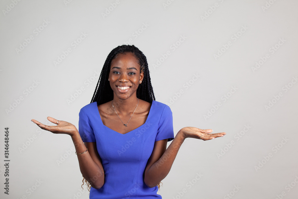 African American woman shrugging her shoulders with palms upturned. African American woman shrugging her shoulders with palms upturned.