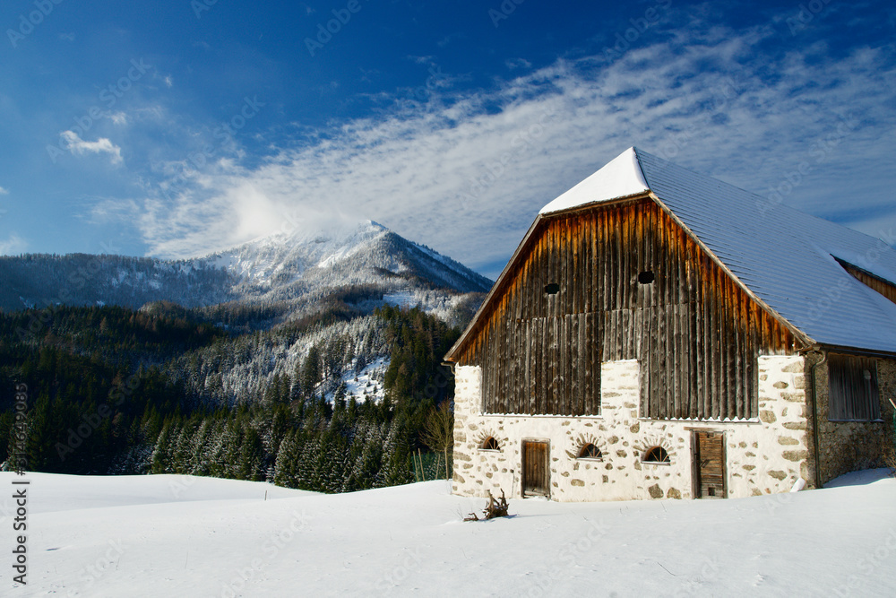 Traditional old barn in the Alps in Europe in Winter