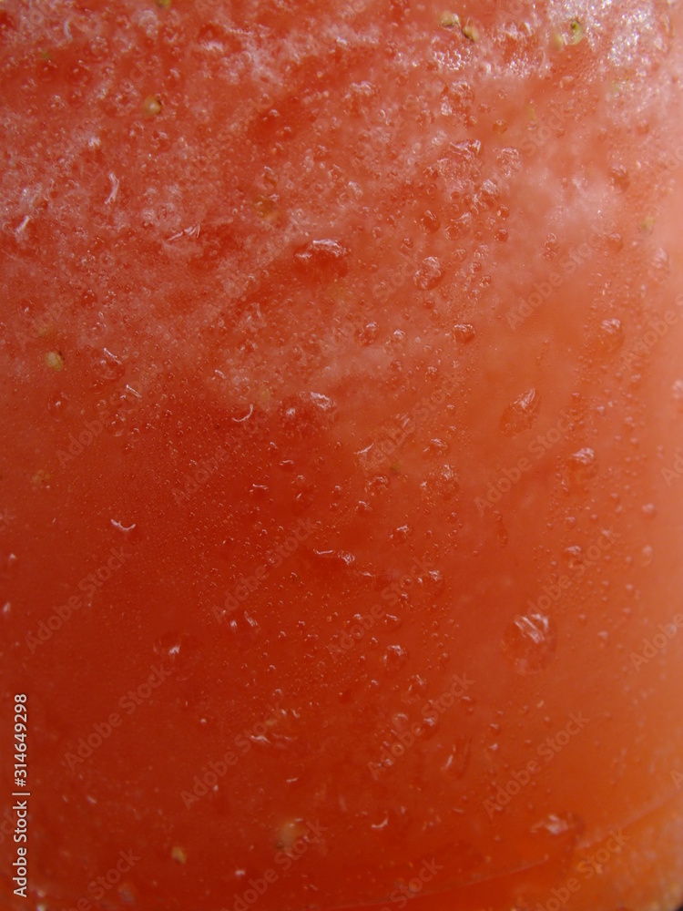 macro image of a glass cup with watermelon juice and water droplets macro image of a glass cup with watermelon juice and water droplets