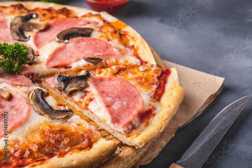 Tasty pizza with mushrooms and ham.  Delicious homemade  pizza