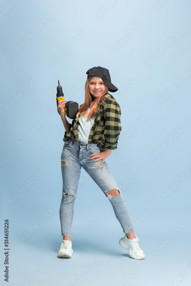 Naklejka premium Smart enought. Girl dreaming about profession of engineer. Childhood, planning, education, dream concept. Wants to be successful employee in manufacturing, building industry, infrastructure, repair.