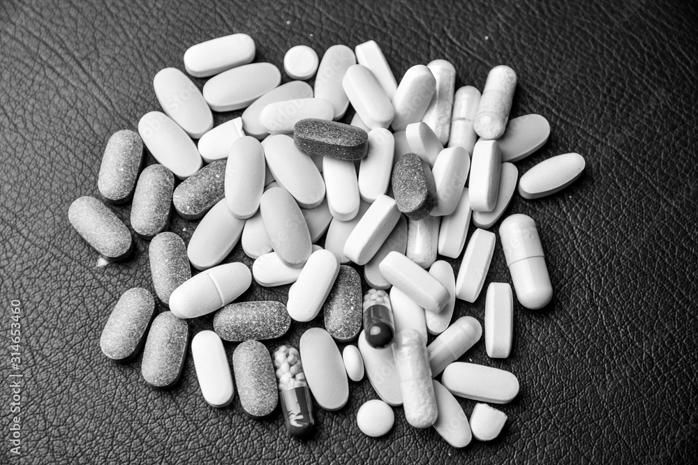 Headache pill on black and white background Headache pill on black and white background