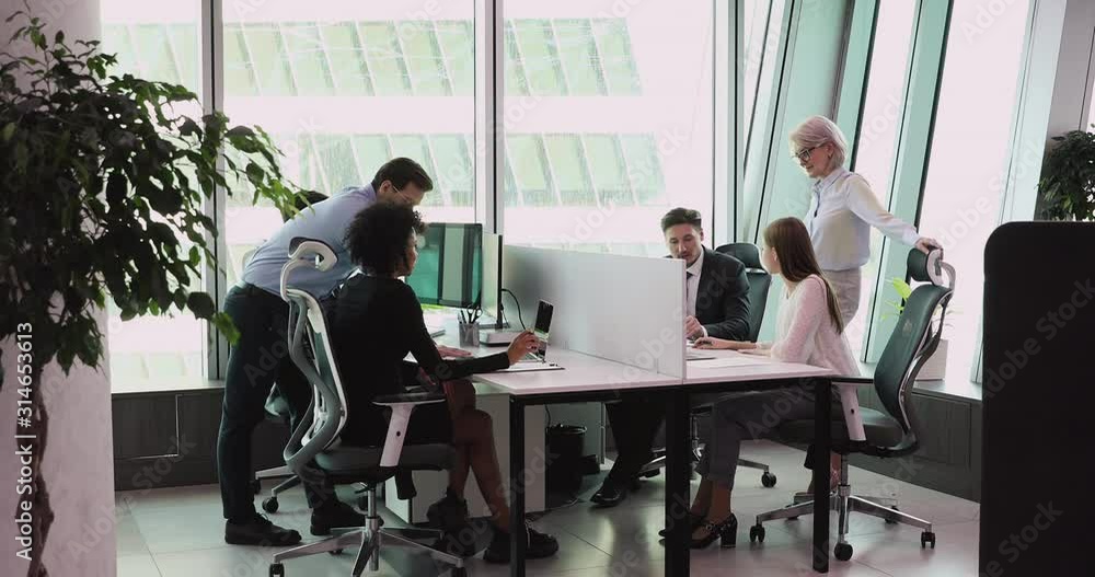 Staff Using One System Multiethnic staff using computers talking in big office Stock Video ...