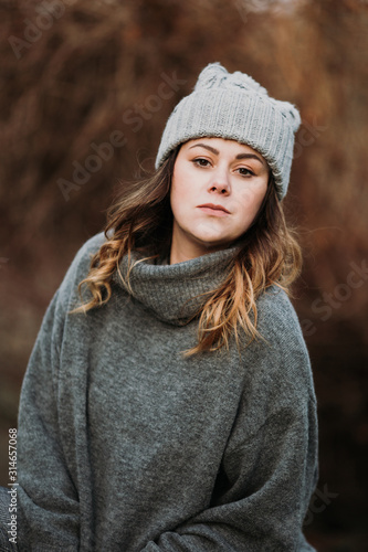 portrait of girl in a grey beanie and sweater