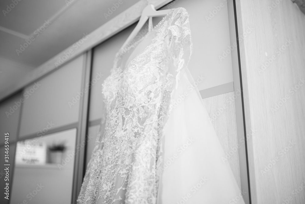 wedding dress hanging on cabinet