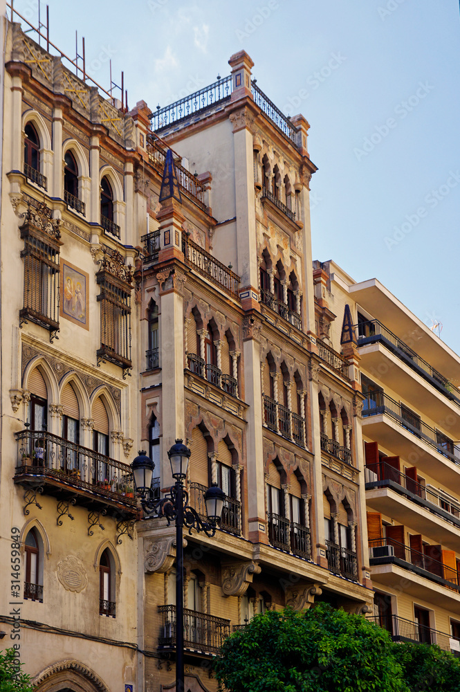 SEVILLE, ANDALUSIA / SPAIN - MAY 10, 2018 - The typical colorful and ornate baroque facade building in the beautiful city of Seville, Spain