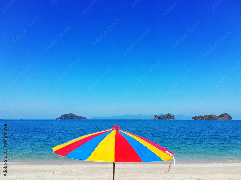 Colored umbrella and crystal clear sea