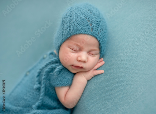 Cute newborn in knitted suit