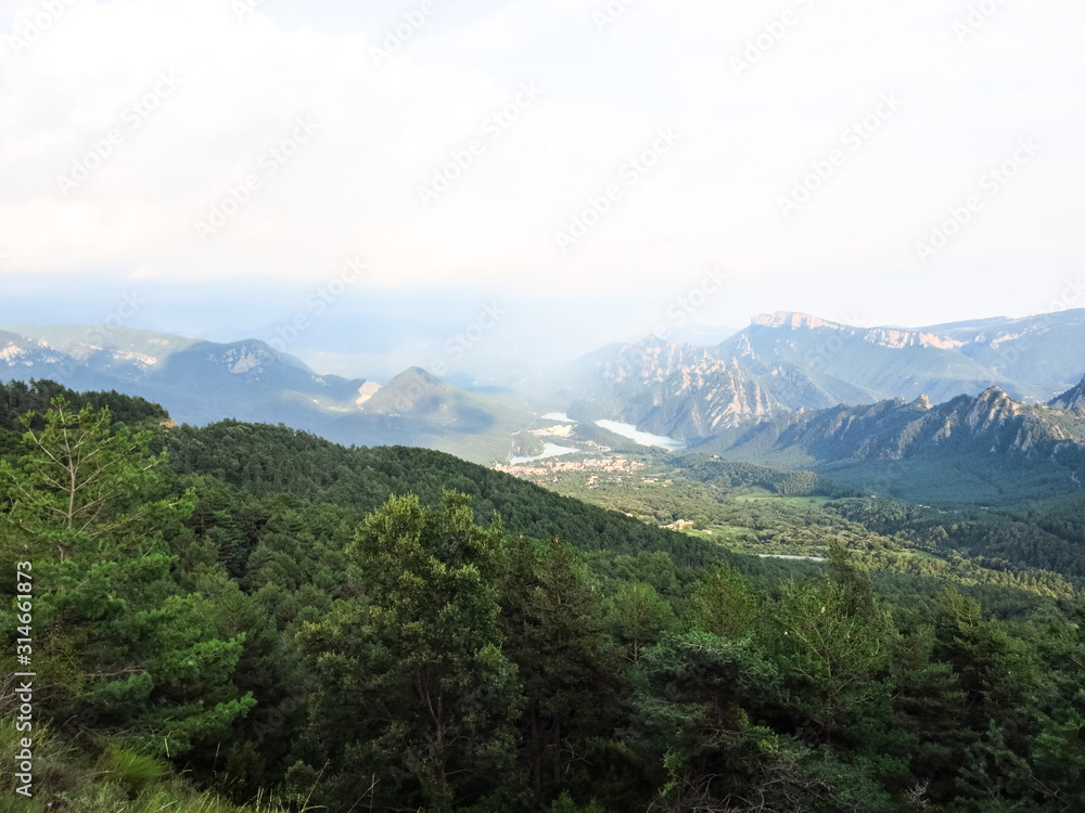 Panoramic view of the pre-Pyrenean area of Catalonia, with the Sierra Cadi, Llosa del Cavall pond and the small town of San Lorenzo de Morunys.