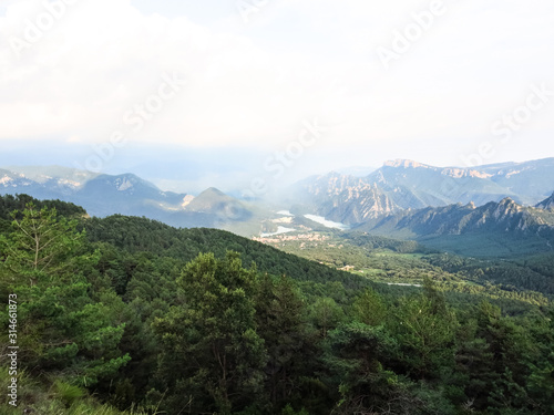 Panoramic view of the pre-Pyrenean area of Catalonia, with the Sierra Cadi, Llosa del Cavall pond and the small town of San Lorenzo de Morunys.