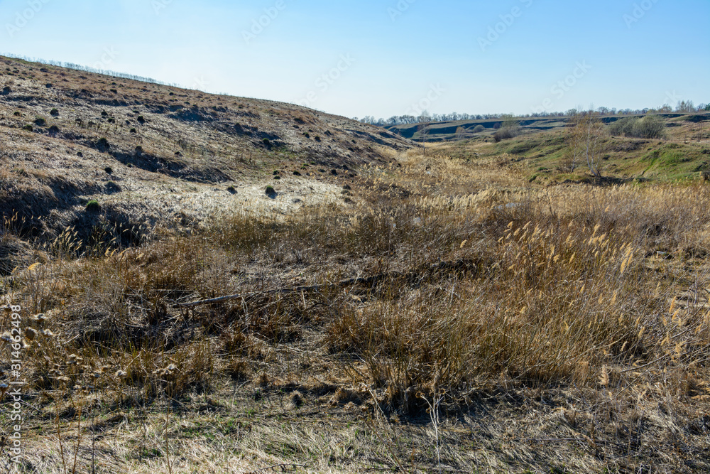 Beautiful spring landscape: trees, forest, mountains, hills, fields, meadows and blue sky. Beautiful spring landscape: trees, forest, mountains, hills, fields, meadows and blue sky.
