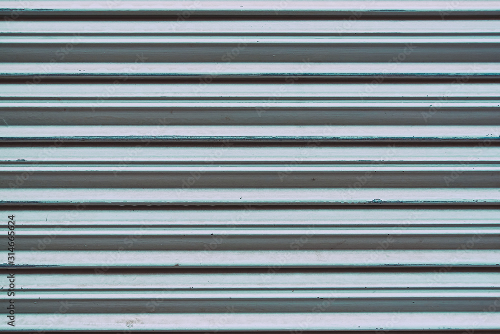detail of metal garage or store door texture; metal background detail of metal garage or store door texture; metal background
