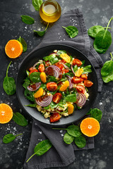 Vegetable Millet salad with red onion, cherry tomatoes, spinach, tangerine and clementine dressing. healthy food
