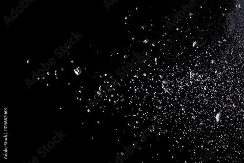 White powder explosion isolated on black background.