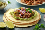 Mexican Corn tortilla with shredded Pork, avocado, red onion and jalapeno