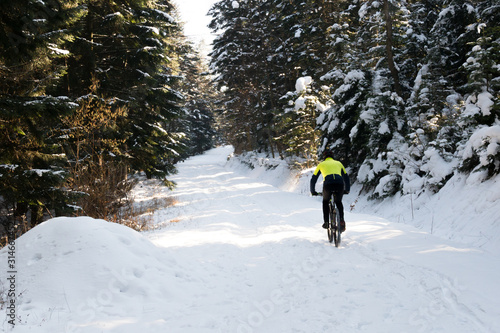 trenning on a bike in the mountains in winter. man on a bicycle