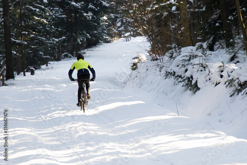 trenning on a bike in the mountains in winter. man on a bicycle