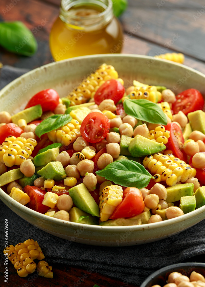 Avocado chickpea salad with grilled sweet corn, tomato and basil. Healthy vegan food Avocado chickpea salad with grilled sweet corn, tomato and basil. Healthy vegan food