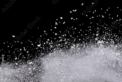 White powder explosion isolated on black background.